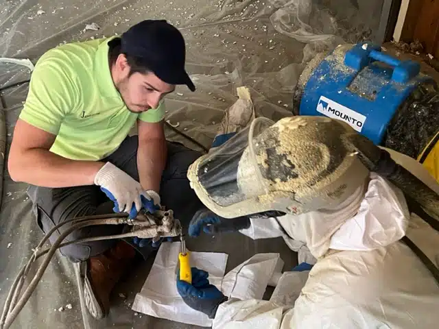 people working to install insulation